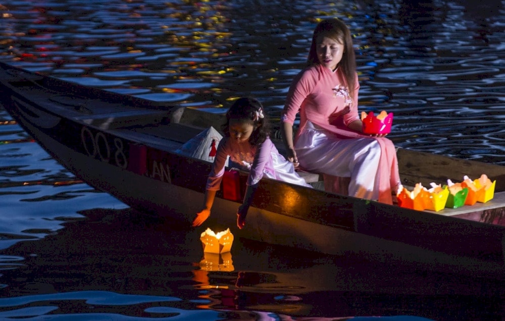 Release glowing lanterns into the water